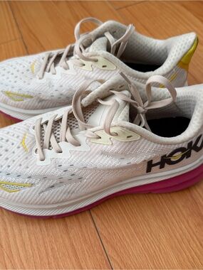Hoka One One White Athletic Shoes with Pink Sole and Yellow Accents